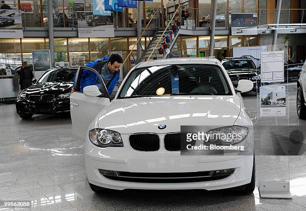 Custumer looks inside a Bayerische Motoren Werke 1 series automobile at a BMW car dealership in Rosenheim, Germany, on Tuesday, May 18, 2010....