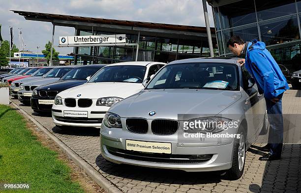 Customer looks at used Bayerische Motoren Werke 1 series cars at a BMW car dealership in Rosenheim, Germany, on Tuesday, May 18, 2010. Bayerische...