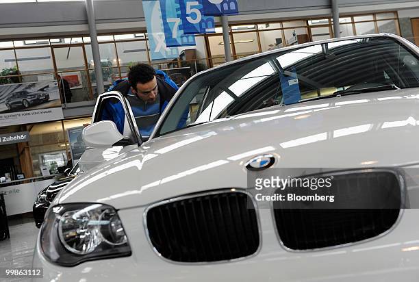 Customer looks inside a Bayerische Motoren Werke 1 series automobile at a BMW car dealership in Rosenheim, Germany, on Tuesday, May 18, 2010....