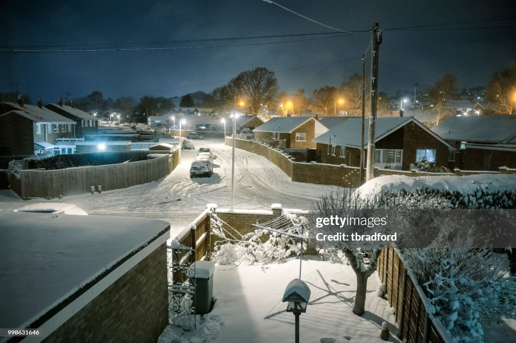 Snow Covered Suburban Scene At Night In The UK