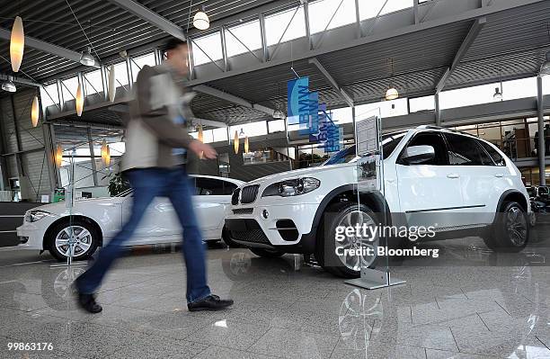 Customer walks through a Bayerische Motoren Werke showroom in Rosenheim, Germany, on Tuesday, May 18, 2010. Bayerische Motoren Werke AG, the world's...