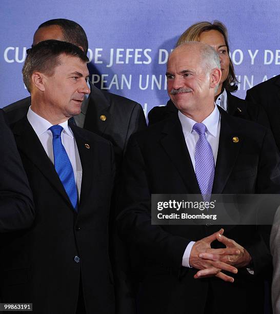 Andrus Ansip, Estonia's prime minister, left, and Georga Papandreou, Greece's prime minister, stand for a group photograph at the European...