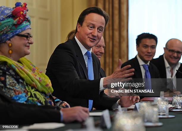 British Prime Minister, David Cameron, , gestures as he chair's 'the Big Society' meeting in the cabinet room of 10 Downing Street in central London,...