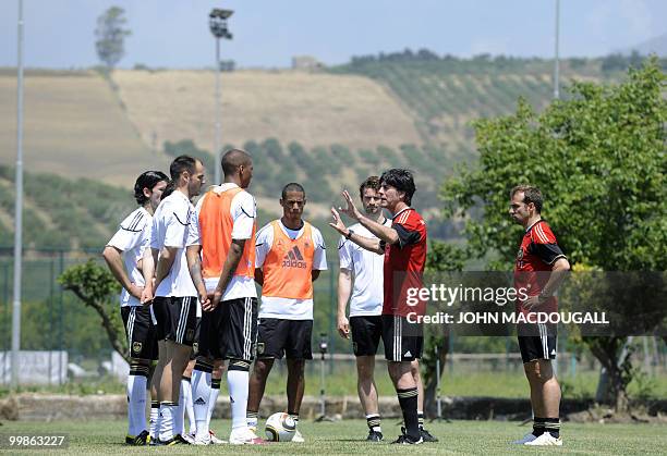 Germany's head coach Joachim Loew explains tactics to his players during a training session at the Verdura Golf and Spa resort, near Sciacca May 18,...