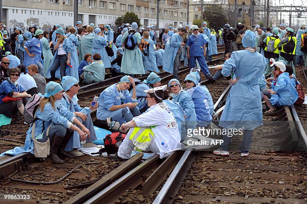 French anaesthetist nurses stand on tracks near the Montparnasse train station on May 18, 2010 in Paris, during a demonstration blocking the speed...
