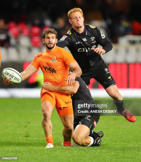 Jaguares' fullback Ramiro Moyano is tackled by Sharks' loose forward Philip van der Walt during the Super Rugby match between the Sharks and the...