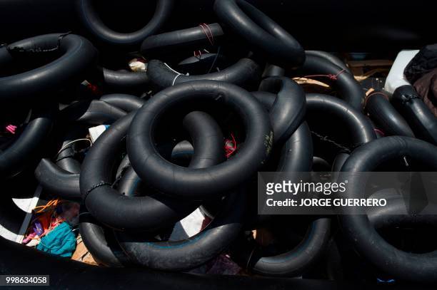 Rubber rings used by migrants on boats to reach the Spanish coast, are pictured at Tarifa's harbour on July 14, 2018. - An inflatable boat carrying...