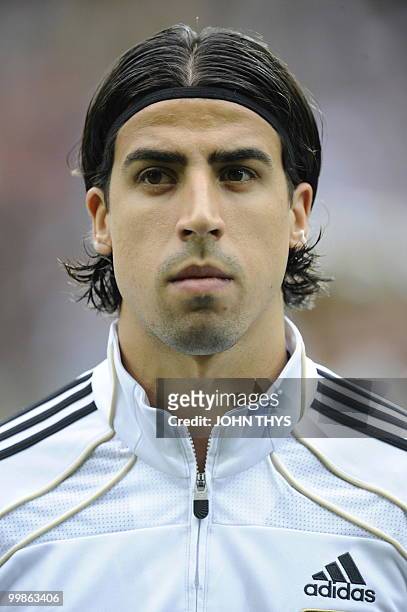 Germany's midfielder Sami Khedira listens to the national anthems ahead of the friendly football match Germany vs Malta in the western German city of...