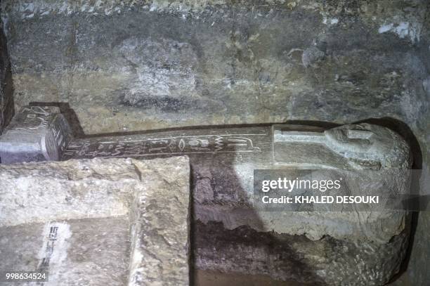 Picture taken on July 14, 2018 shows a sarcophagus inside a burial chamber, in the Saqqara necropolis, south of the Egyptian capital Cairo on July...