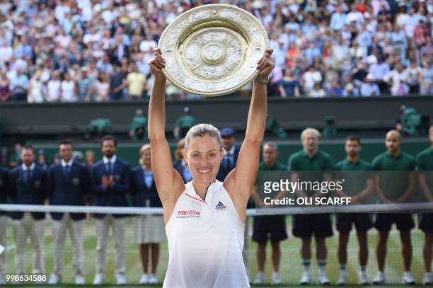 Germany's Angelique Kerber poses with the winner's trophy, the Venus Rosewater Dish, after her women's singles final victory over US player Serena...