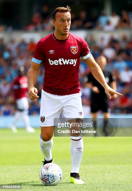 Mark Noble of West Ham runs with the ball during the pre-season friendly match between Wycombe Wanderers and West Ham United at Adams Park on July...