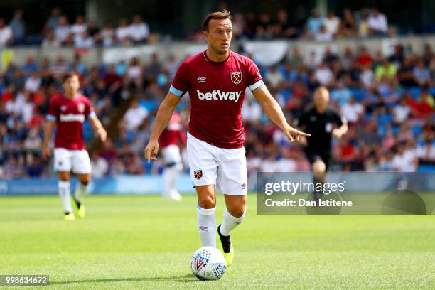 Mark Noble of West Ham runs with the ball during the pre-season friendly match between Wycombe Wanderers and West Ham United at Adams Park on July...