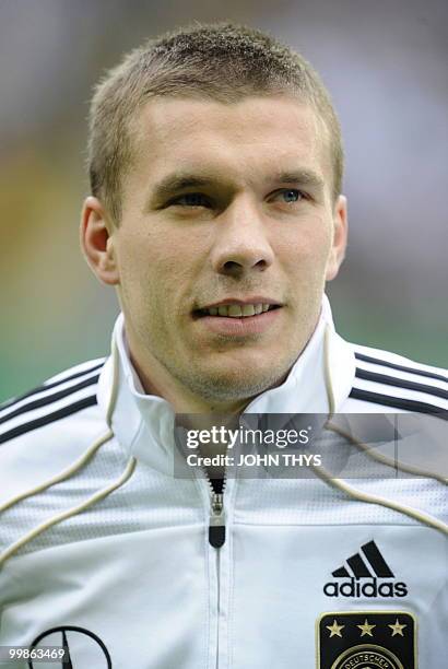 Germany's striker Lukas Podolski listens to the national anthems ahead of the friendly football match Germany vs Malta in the western German city of...