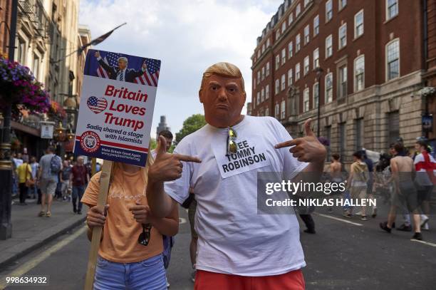 President Donald Trump supporters pose for the camera as they mix with protesters at a rally by supporters of far-right spokesman Tommy Robinson in...