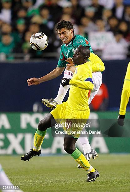 Hector Moreno of Mexico and Djibril Sidibe of Senegal battle for control of the ball during an international friendly at Soldier Field on May 10,...