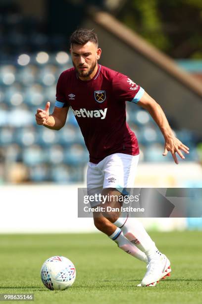 Robert Snodgrass of West Ham runs with the ball during the pre-season friendly match between Wycombe Wanderers and West Ham United at Adams Park on...