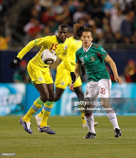 Mame Saher of Senegal and Andres Guardado of Mexico follow the ball during an international friendly at Soldier Field on May 10, 2010 in Chicago,...