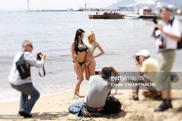 Hungarian model and actress Aletta Ocean and Czech actress Tarra White pose in bikini on the beach during a photocall on the sidelines of the 63rd...