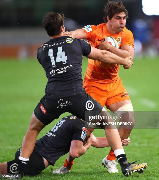 Jaguares loose forward Pablo Matera is tackled by Sharks wing Kobus van Wyk during the Super Rugby match between the Sharks and the Jaguares at the...