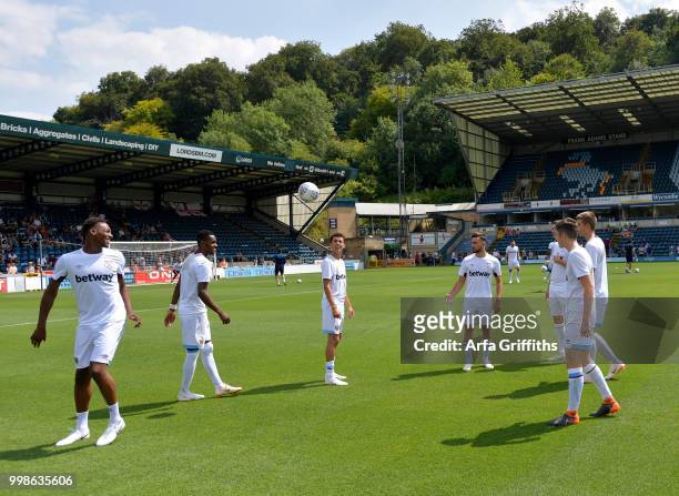 Players of West Ham United warm up before the Pre Season Friendly between Wycombe Wanderers and West Ham United at Adams Park on July 14, 2018 in...