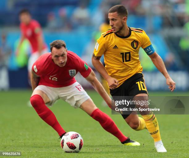 Defender Phil Jones of England National team and Forward Eden Hazard of Belgium National team during the third place match between Belgium and...