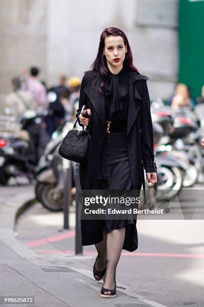 Guest wears a black coat, a black skirt, a black bag, outside Lanvin, during Paris Fashion Week - Menswear Spring-Summer 2019, on June 24, 2018 in...