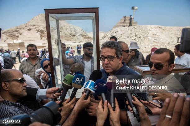 Egyptian Minister of Antiquities, Khaled el-Anani, speaks to the press in front of the step pyramid of Saqqara, south of the Egyptian capital Cairo...