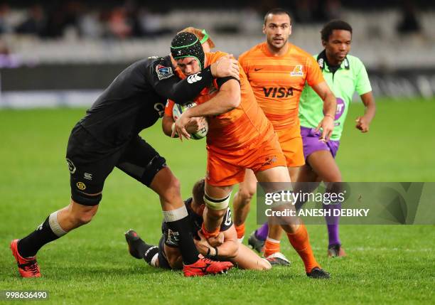 Jaguares' lock Matias Alemanno is tackled by Sharks' loose forward Philip van der Walt during the Super Rugby match between the Sharks and the...