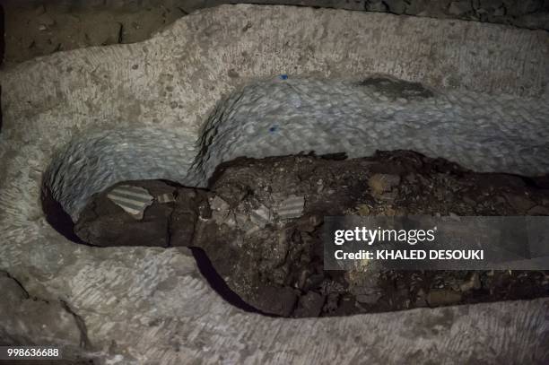 Picture taken on July 14, 2018 shows a sarcophagus inside a burial chamber, in the Saqqara necropolis, south of the Egyptian capital Cairo on July...