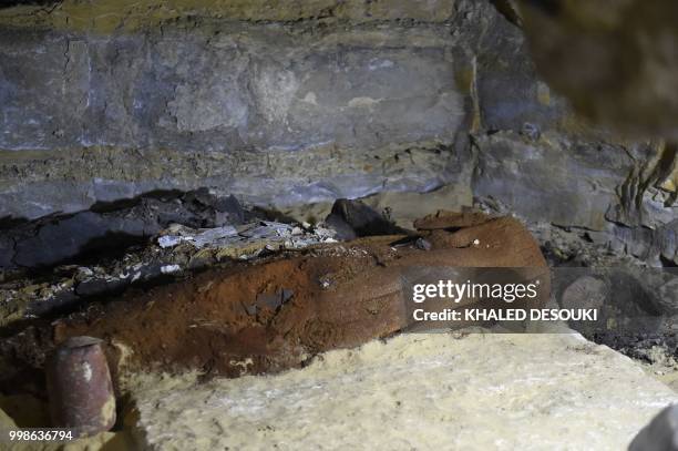 Picture taken on July 14, 2018 shows a sarcophagus inside a burial chamber, in the Saqqara necropolis, south of the Egyptian capital Cairo on July...