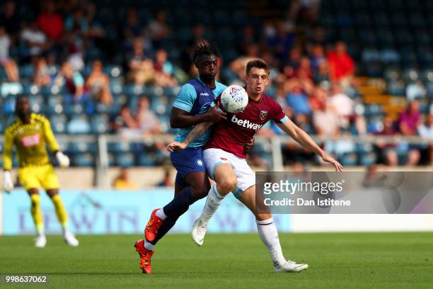 Jordan Hugill of West Ham battles for the ball with Anthony Stewart of Wycombe during the pre-season friendly match between Wycombe Wanderers and...