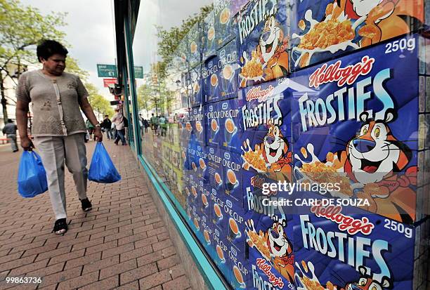 Woman looks in the window of a food store in Hounslow, west London on May 18, 2010. British annual inflation hit a 17-month high in April, official...