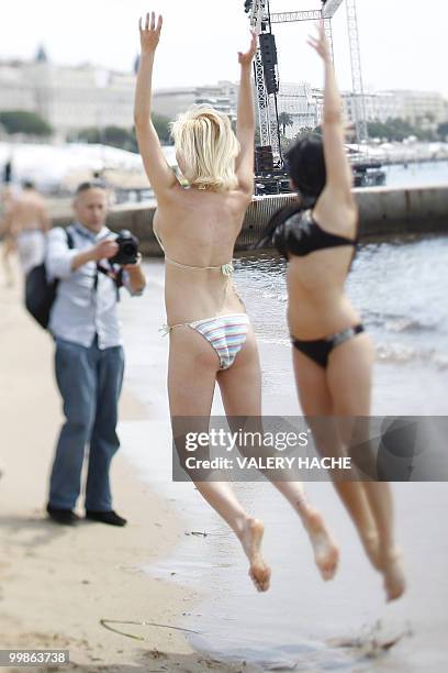 Hungarian model and actress Aletta Ocean and Czech Tarra White poses in bikini on the beach during a photocall on the sidelines of the 63rd Cannes...