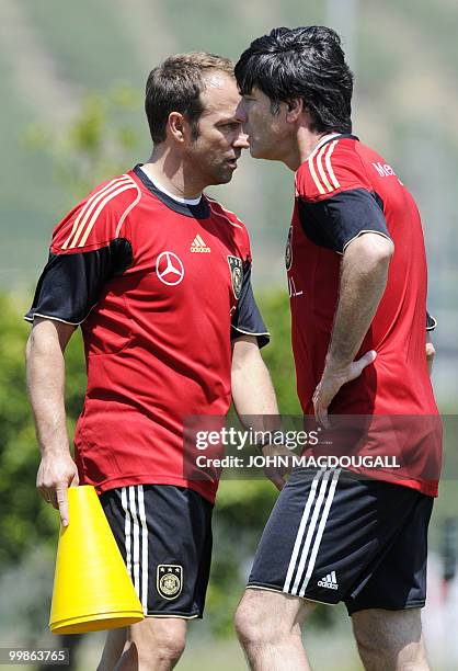 Germany's head coach Joachim Loew and Germany's co-trainer Hansi Flick cross paths during a training session at the Verdura Golf and Spa resort, near...