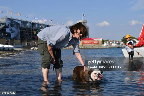 French actress and singer Jane Birkin poses for a picture with her dog named "Dolly", during the 34th edition of the Francofolies Music Festival in...