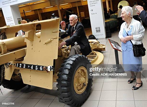 World War II veteran John Garrett is watched by his wife as he climbs aboard a 25-pounder gun, during an event to mark the 70th anniversary of...