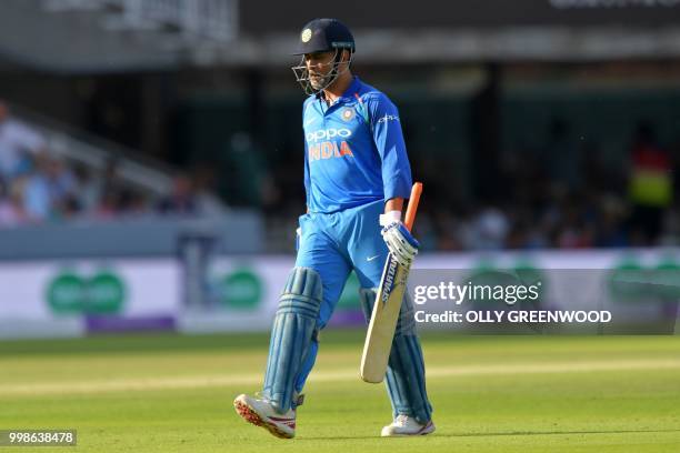 India's MS Dhoni walks back to the pavilion after losing his wicket for 37 during the second One Day International cricket match between England and...