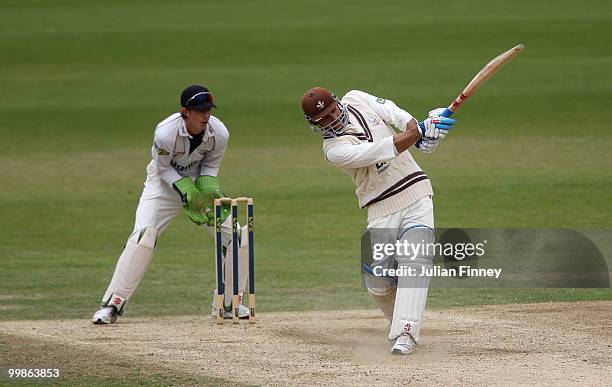 Mark Ramprakash of Surrey in action as John Simpson of Middlesex watches on during day two of the LV= County Championship Division Two match between...