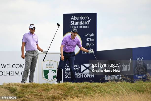 Ian Poulter of England and Russell Knox of Scotland look on, from the tee of hole two during day three of the Aberdeen Standard Investments Scottish...