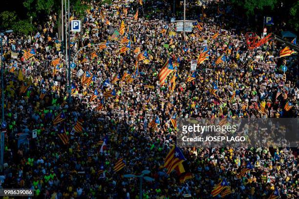 People attend a demonstration on July 14, 2018 in Barcelona, calling for the release of separatist leaders held over their role in the region's...