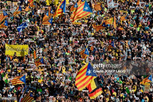 People attend a demonstration on July 14, 2018 in Barcelona, calling for the release of separatist leaders held over their role in the region's...