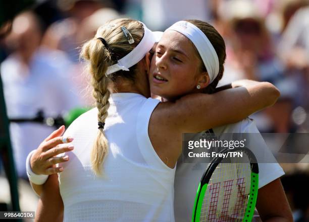 Jelena Ostapenko of Latvia embraces Angelique Kerber of Germany in the ladies' semi finals at the All England Lawn Tennis and Croquet Club on July...