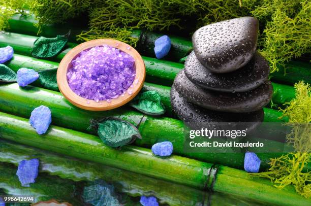 stack of black stones and salt for massage and bath - bath salt stock-fotos und bilder