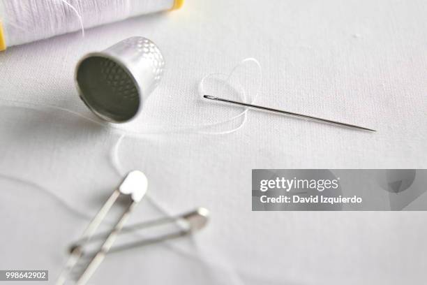 sewing tools closeup on white fabric elevated view - thimble stock pictures, royalty-free photos & images