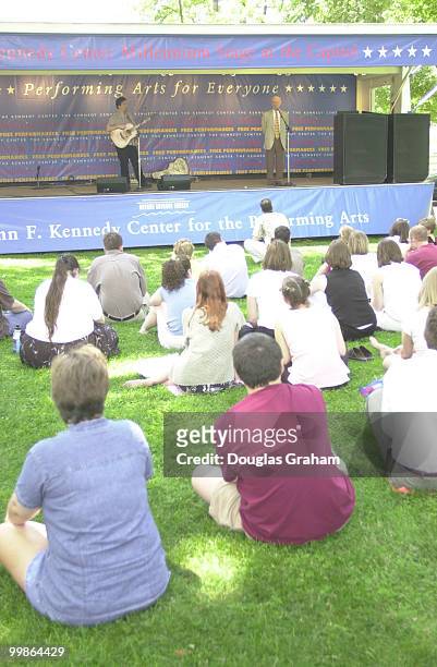 Peter Mulvey guitarist from Milwaukee entertains a crowd and James L. Oberstar, D-Minn., on the East Lawn as part of the John F. Kennedy Center for...