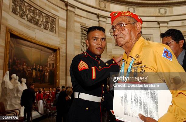 John Brown, Jr., Navajo Code Talker, gets a pat on the back from a young Marine after he received the Congressional Gold Medal in the U.S. Capitol.
