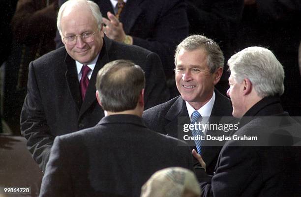 After being sworn in as the 43rd President of the United States George W. Bush shakes hands with President Bill Clinton and Vice President Al Gore on...