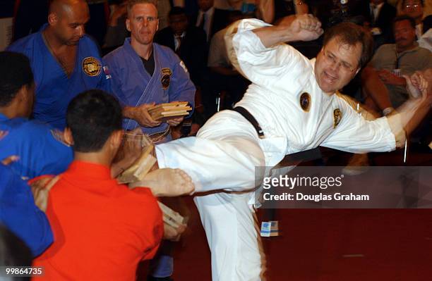 Bob Schaffer, R-Colo., breaks boards as part of his black belt test in the Cannon Caucus room.