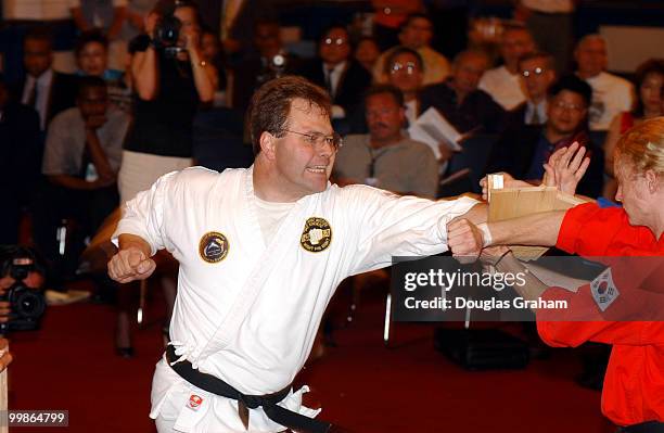 Bob Schaffer, R-Colo., breaks a board during his black belt test in the Cannon Caucus room.