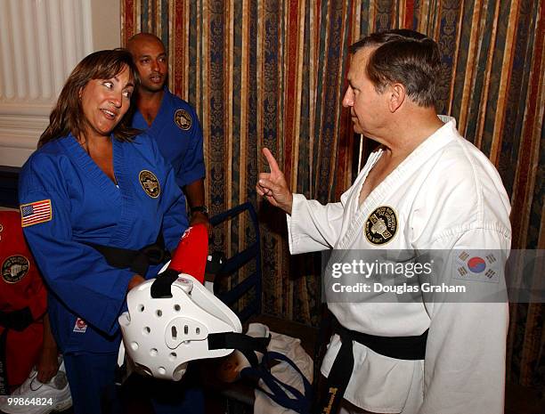 Nick Smith, R-Mich., gets some pointers from Brigitte Anwar before the start of there black belt test in the Cannon Caucus room.